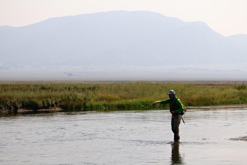 Fly fisherman on a plains river